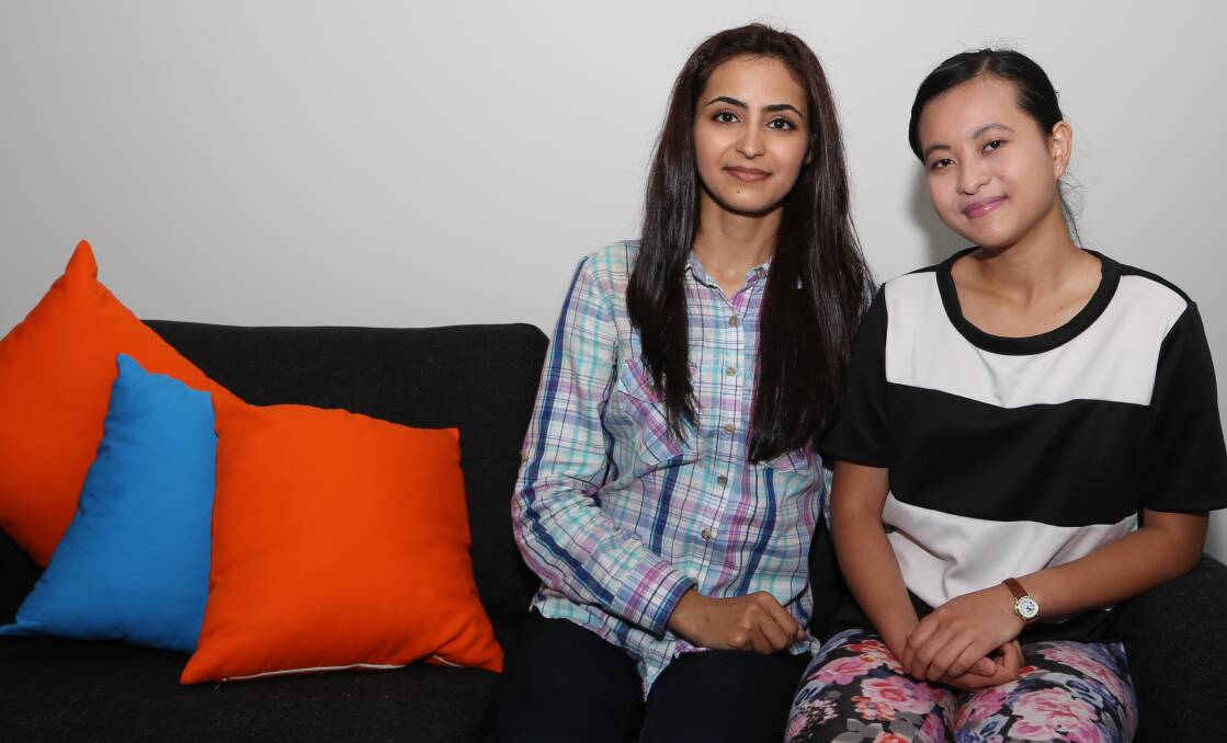 Helping others: Young refugee women Azita and Elizabeth volunteer to support other families in Wollongong. Picture: Greg Ellis
