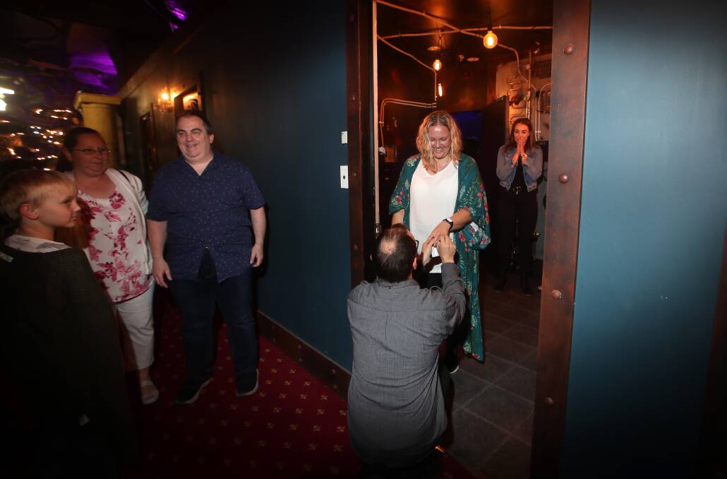 Unexpected moment: The look of disbelief when David Hunter gets down on one knee for Glenda Hunter in front of friends at Breakout Bar and Escape Rooms in Wollongong on Sunday. Picture: Sylvia Liber.