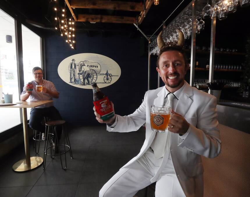 Cheers to that: Marc Swan and Neil Webster at the Furphy Bar which is one of two new venues for Santa Claus Pub Crawl this year. Picture: Robert Peet.

