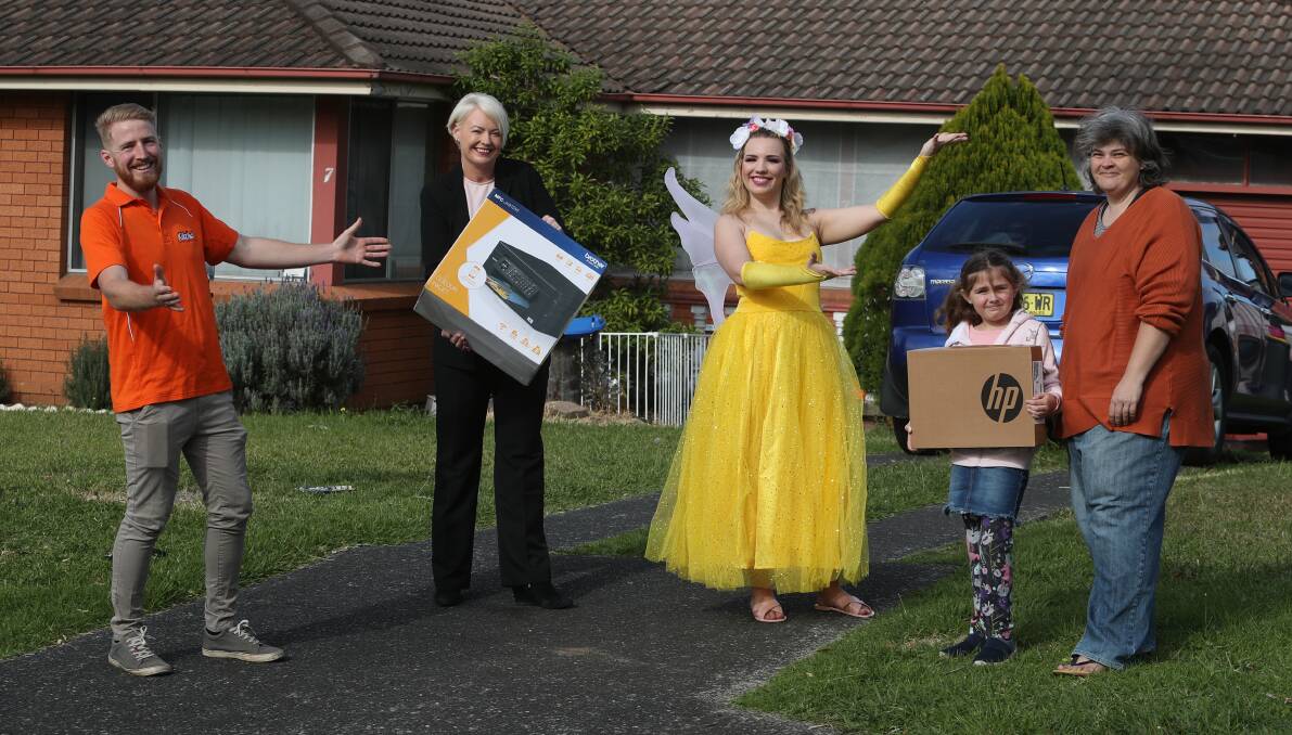 Wish granted: The KidzWish Fairy and general manager Julie Gemmell deliver a new PC and printer to Arinya Locke in Figtree. Picture: Robert Peet 