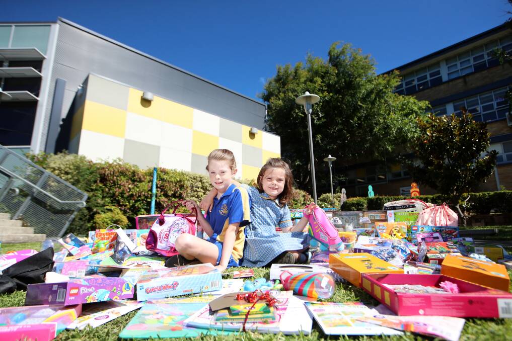 Heart of gold: Indigo Marmont, 9, and Charlotte Marmont, 6, and the toys collected for sick kids in hospital this Christmas. Picture: Sylvia Liber.
