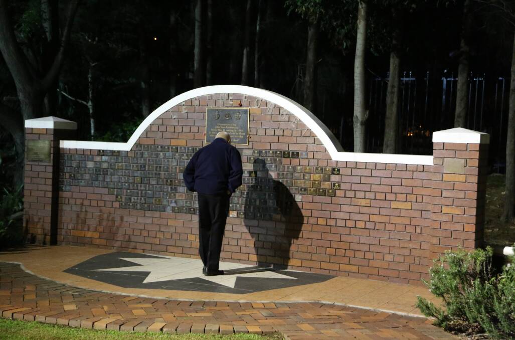 Reflection: Many arrived early for the Thirroul dawn service to remember those who fought for Australia over many decades. Picture: Greg Ellis.