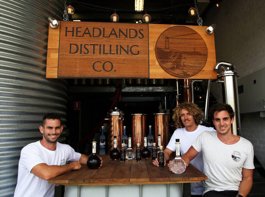 Lifting their spirits: Lachlan Hingley, Jared Smith and Dean Martelozzo with the growing Headlands Distilling range at Fairy Meadow. Picture: Greg Ellis. 