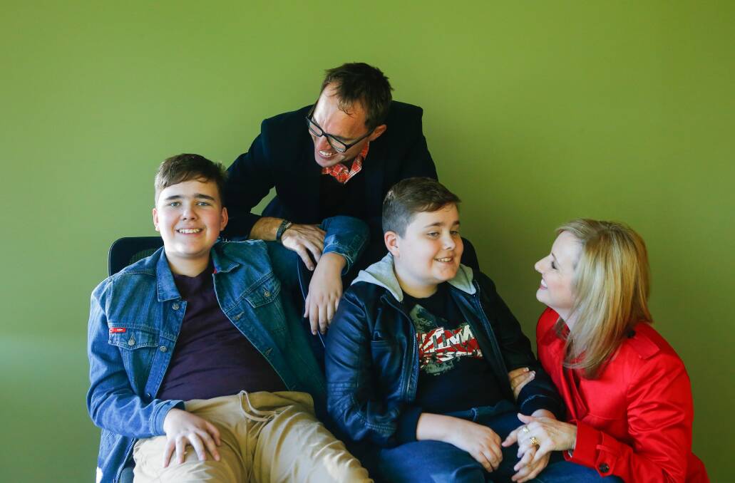 Helping families with autism: Brad and Jenn Ratcliffe with their boys Cameron and Coby who are loving the app their parents have developed. Picture: Adam McLean.