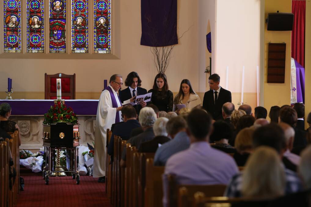 Family: Great nieces and nephews Isaac Gargett, Lola Brown, Grace Gargett and Callum Brown reading prayers at John Peter Comelli's funeral on Friday at St Frances Xavier church. Picture: Robert Peet.
