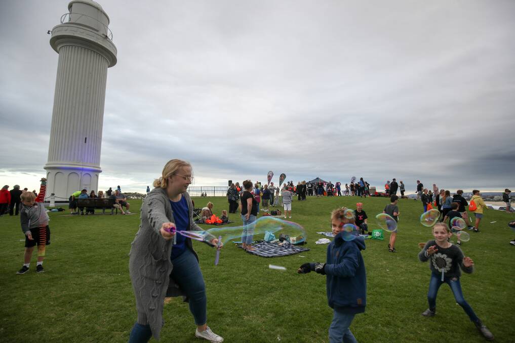 Raising awareness: Big Fat Smile volunteer Marika Tults makes bubbles for the kids ​at Flagstaff Hill on Tuesday night for World Autism Day. Picture: Adam McLean.

