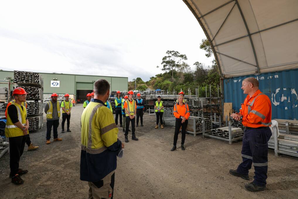 Trying Scaffolding for a Day: KJ Scaffolding's Work Health and Safety labour manager Kieran McGartland (right) speaking with potential trainees at KJ's scaffolding yard in Cringilla on Friday. Picture: Adam McLean.
