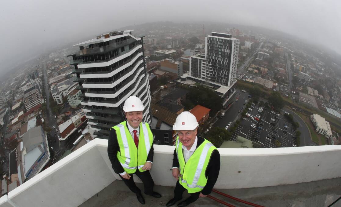 Recognition: Illawarra Business Chamber executive director Adam Zarth and IMB Bank chief executive Robert Ryan on top of the 21-storey Signature Wollongong building and preparing to take the annual business awards to new heights despite COVID-19. Picture: Robert Peet with access provided by MMJ Wollongong.. 