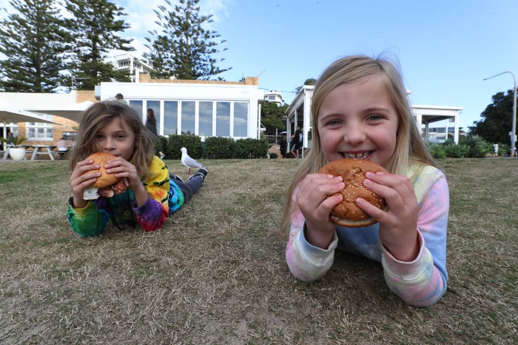 Good fortune: Rio Morand, of Wollongong, and Stevie Blake, of West Wollongong, tucking in to a free bacon and egg roll from Diggies. Picture: Robert Peet.