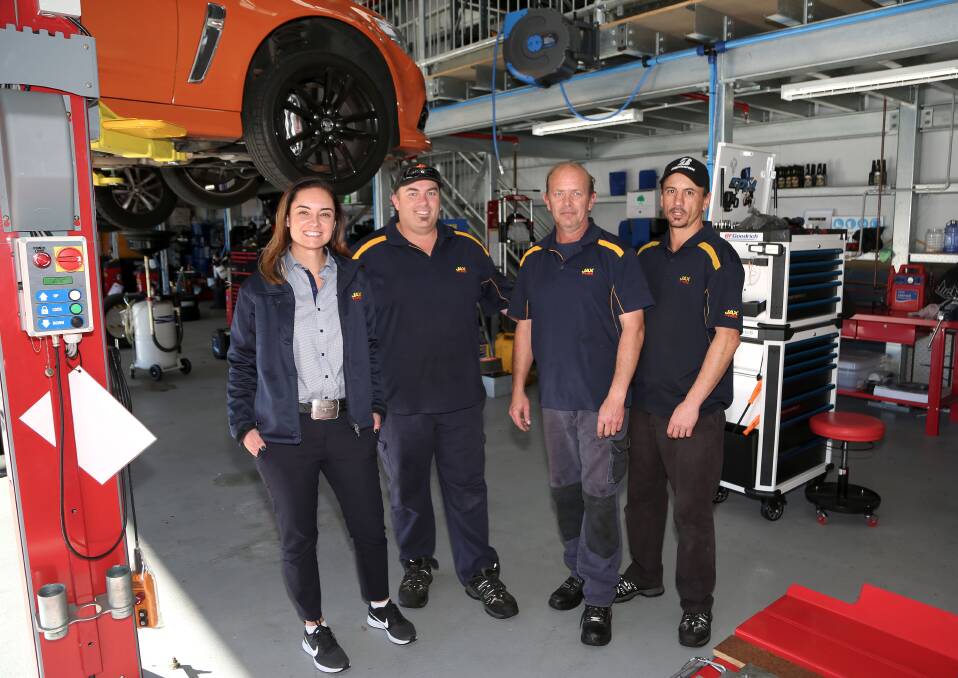 In the workshop: Bec Bull with some of her team in the workshop at the new Jax Tyres outlet she is the owner and apprentice at in Warrawong. Pictures: Greg Ellis.



