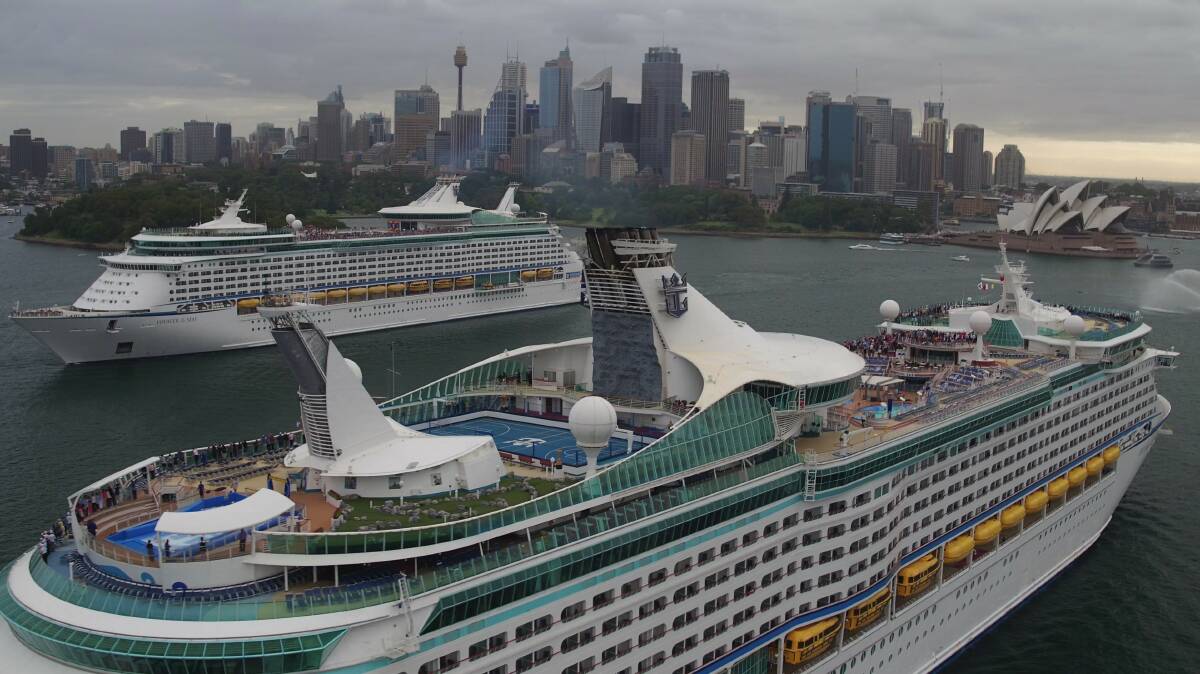 Welcome sis: Sister ships Voyager and Explorer of the Seas passing in Sydney Harbour.
