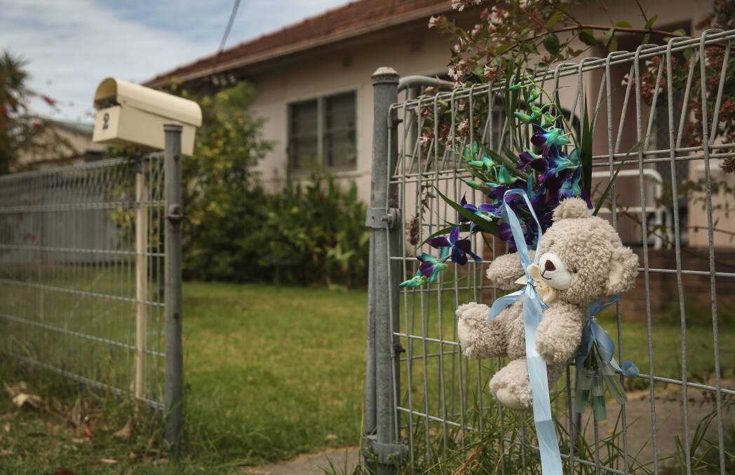 TRAGEDY: Tributes to the baby boy were yesterday tied to the fence of the New Lambton home where he was staying before he died. Picture: MARINA NEIL