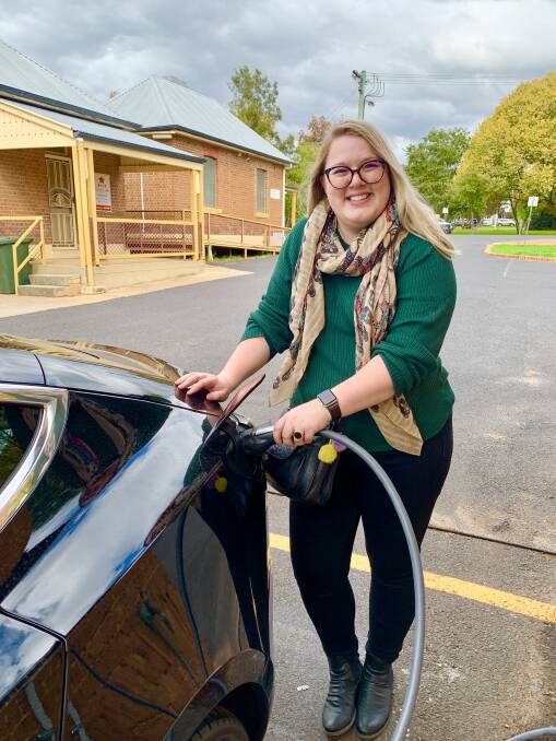 My partner, Madeline, topping up the car in Mudgee while we head to the weekend markets.