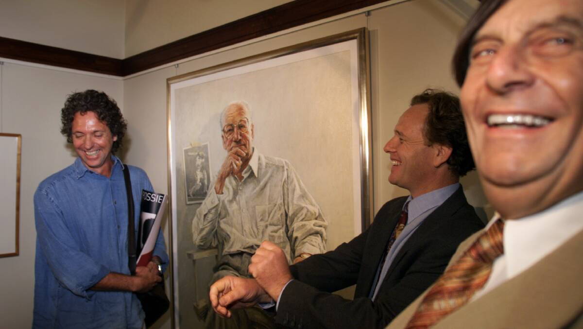 ARTIST: Bill Leak (left) with his portrait of Don Bradman. On the right is the great Barry Humphries. 