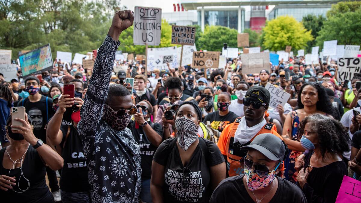 Rally: Civil rights protesters chant before a march in honour of George Floyd on Tuesday in Houston, Texas. Picture: Getty Images