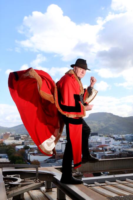 Lord Mayor Gordon Bradbery posing high above Wollongong in a special photo shoot for Comic Gong 2018. Picture: Sylvia Liber. Front page art work: Josh Hall.