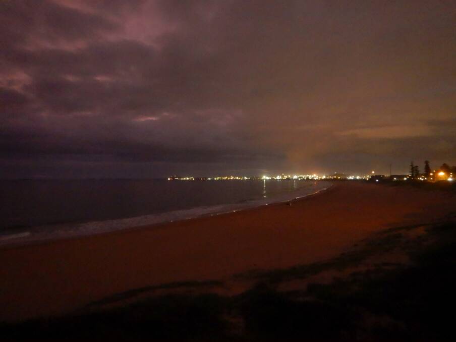 City Beach, Port Kembla lights under a  leaden sky by Hans Haverkamp