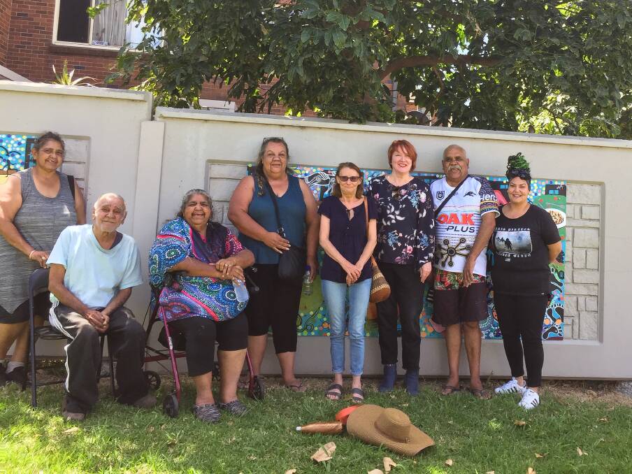 TEAM EFFORT: Coomaditchie United Aboriginal Artists with District Director at Department of Communities and Justice Helen Board. Picture: Contributed. 