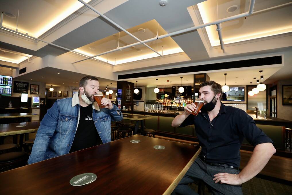 TRYING TIMES: Hotel Illawarra publican Ryan Aitchison and hotel manager Will Barwick shared a brew on the back of the COVID restrictions being announced on Wednesday. Picture: Adam McLean.