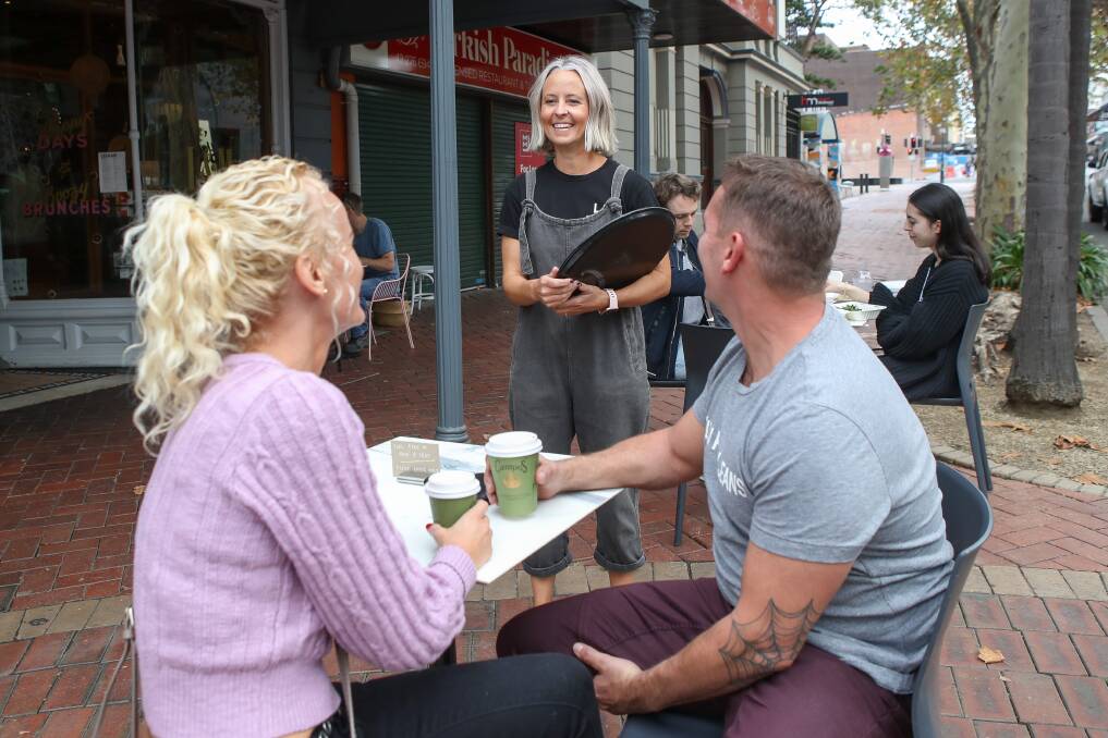 ALL SMILES: Co-owner of Lee and Mee cafe Shay Sullivan speaking with customers after the NSW government lifted CODIV-19 gathering restrictions. Picture: Adam McLean.
