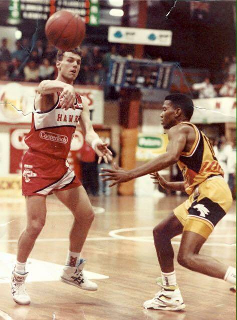 HAWKS PASSION: Former player and now fan Chris Brettell in his playing days being guarded by Perth great Ricky Grace.