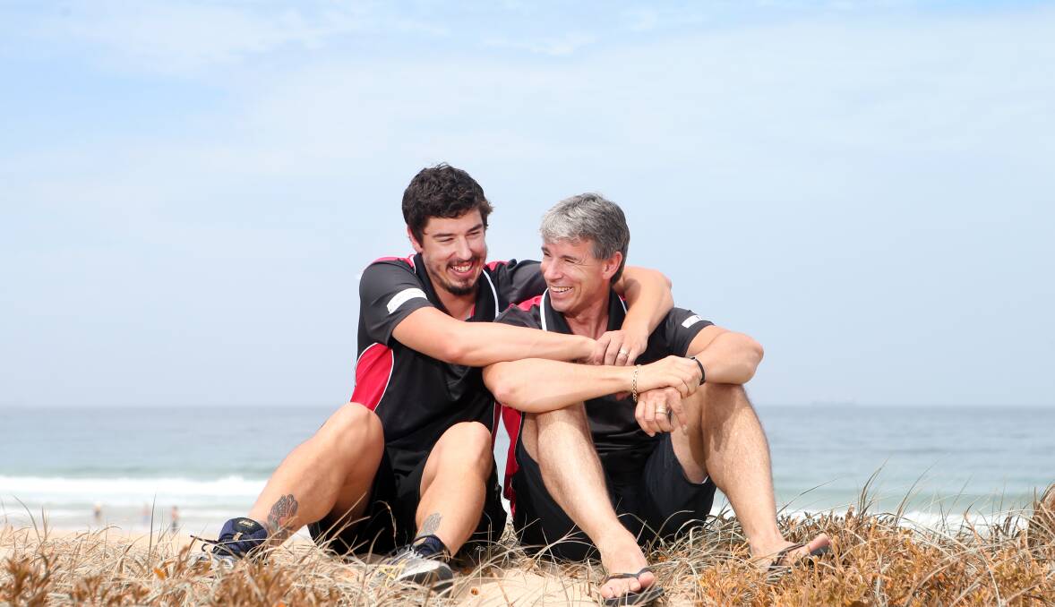 FATHER AND SON: Cody Ellis and his father Mike relax at Wollongong's City Beach during the week. Mike will be cheering his son on courtside against his old side, the Perth Wildcats, on Saturday night. Picture: Sylvia Liber.