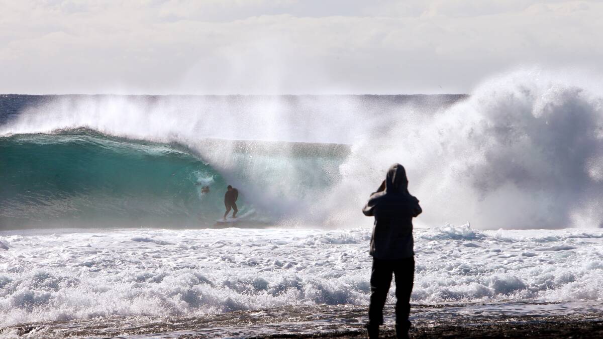 Surfers enjoy the swell rolling in to Cowries at Shellharbour. Pictures: Sylvia Liber. 