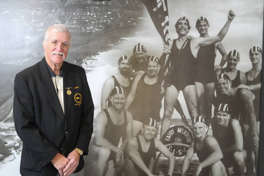 HONOURED: Lawrence (Lou) Bond who has received an OAM for more than 60 years service to Fairy Meadow SLSC. He is pictured in the photo mural as a younger man (arms in the air) with other surf club member Picture: Adam McLean.