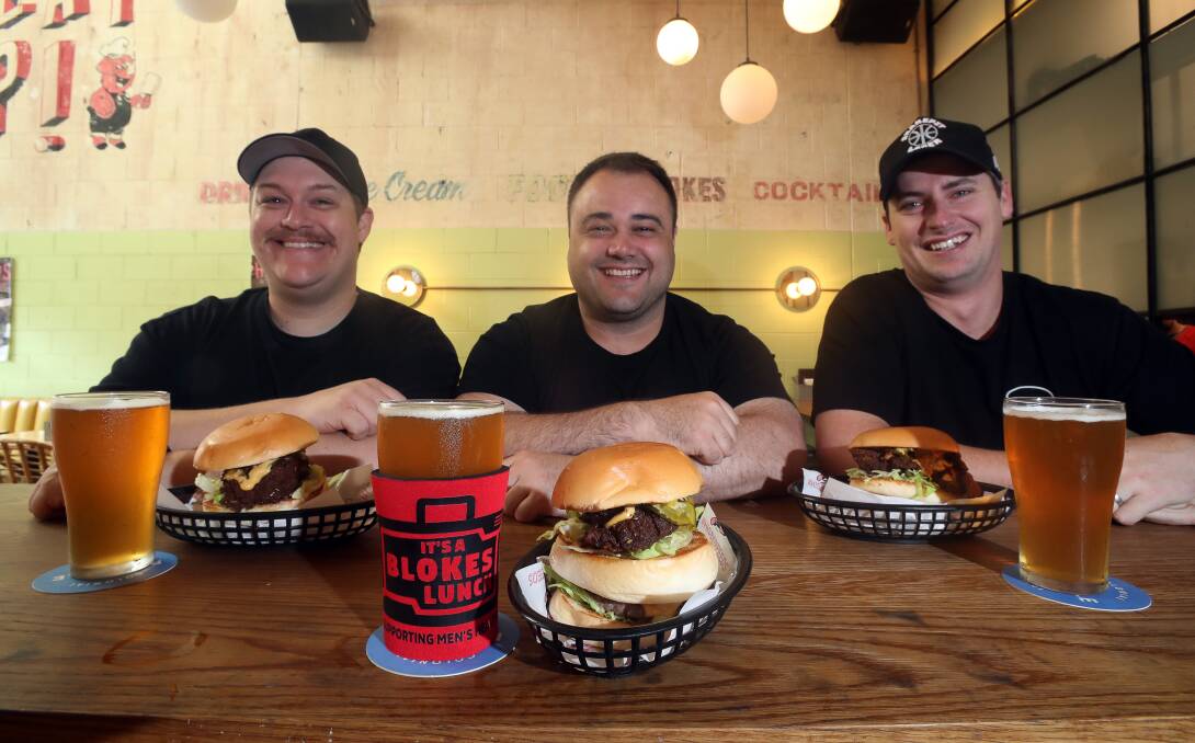BURGER TIME: Daniel Chin, Josh Tree from the Blokes Lunch and Lachlan Stevens with the Blokes Burger on sale at His Boy Elroy. Picture: Robert Peet