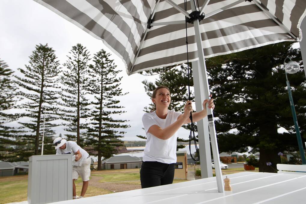Heidi Ekman putting up an umbrella at the new Diggies Kiama which will be open on Thursday, December 19. Picture: Adam McLean. 