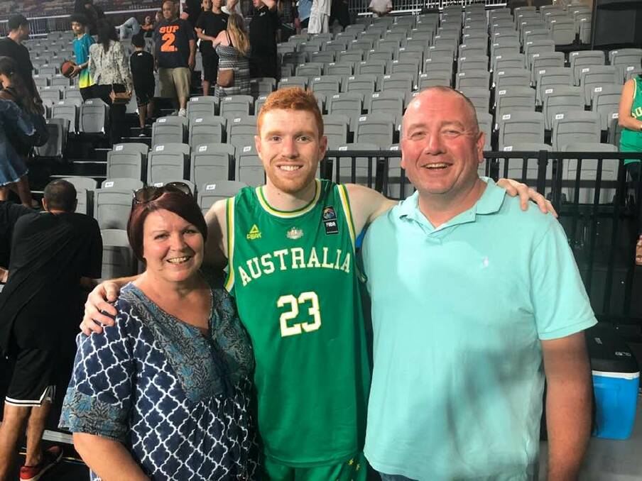 NEW BOOMER: Angus in Brisbane with the Boomers on Thursday night with mum Mandy and dad Al. 