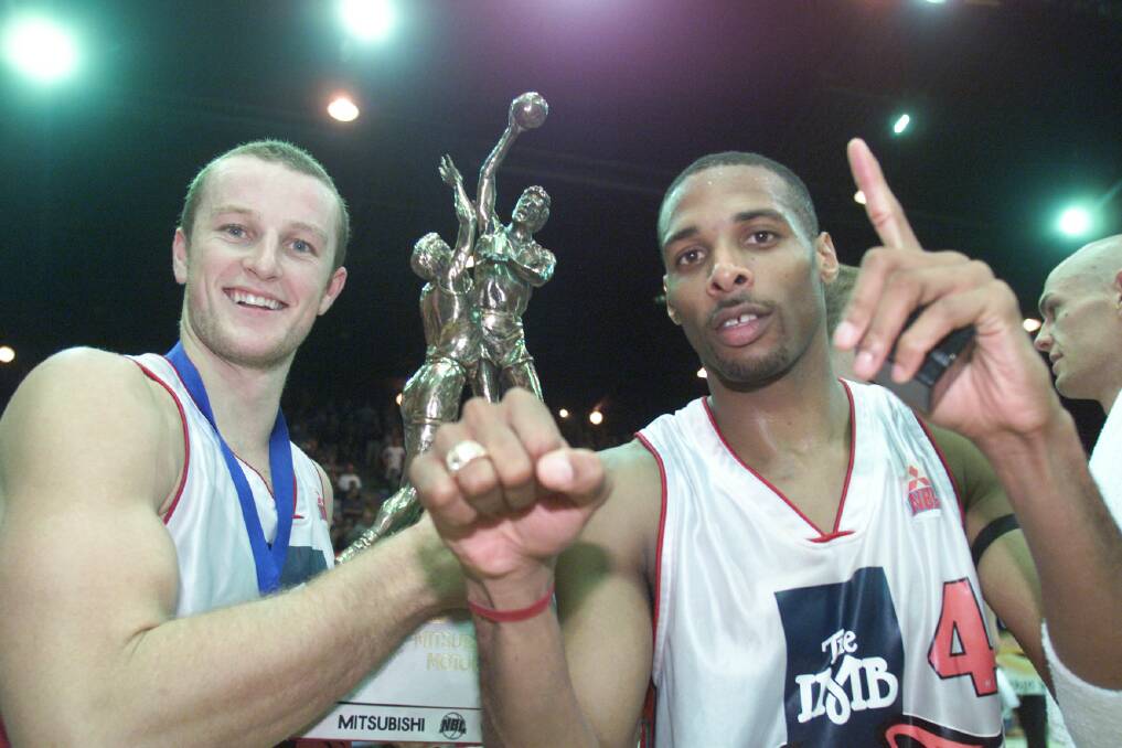 Glen Saville and Charles Thomas with trophy and championship rings after defeating the Crocodiles in the best of three finals series in Townsville in 2001. It's the NBL Foundation Club's only title. 