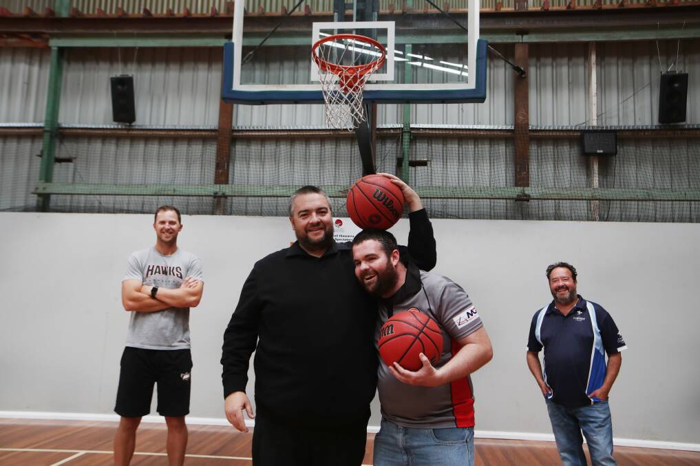 HAWKHEADS: (from left) Former Hawks player Tim Coenraad, local businessman Dan Muller, his brother Ethan and Michael Norris of the Disability Trust. Picture: Sylvia Liber 