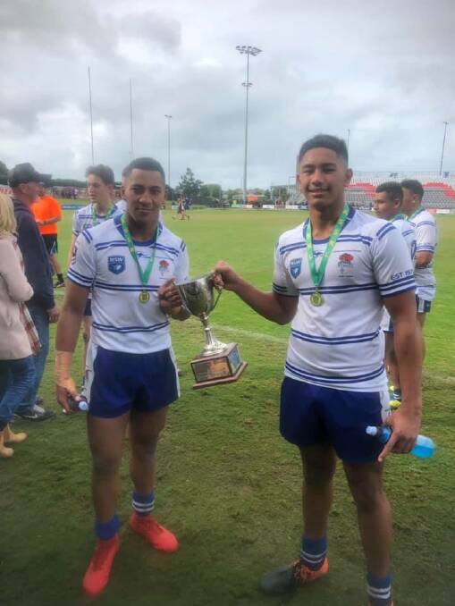 JC Ngarima (right) holds the trophy after the Australia Secondary Schools Championships in Redcliffe earlier this month.