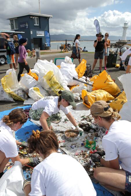 Volunteers survey some of the 38 bags of rubbish collected during the first ever Wollongong Harbour Land And Sea Clean Up. Pictures: Adam McLean
