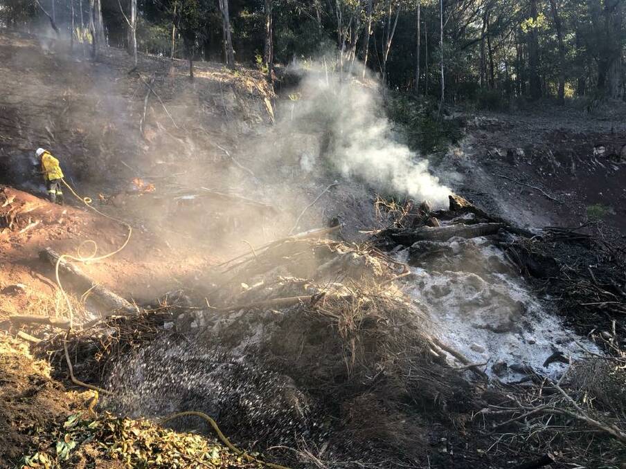 Firefighters extinguish an escaped burn at Otford on Monday. Gusty winds and the lengthy dry spell combine for potentially dangerous fire conditions, even during the middle of winter, according to the Rural Fire Service (RFS). Picture: NSW RFS Illawarra District