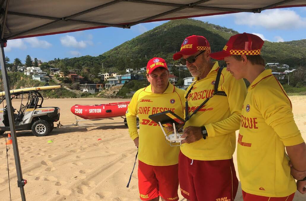 EYE IN THE SKY: Lifesavers Steven McDonald (left), Mike Malherbe and Lachlan McDonald with the new drone at Stanwell Park beach. Picture: Surf Life Saving Illawarra