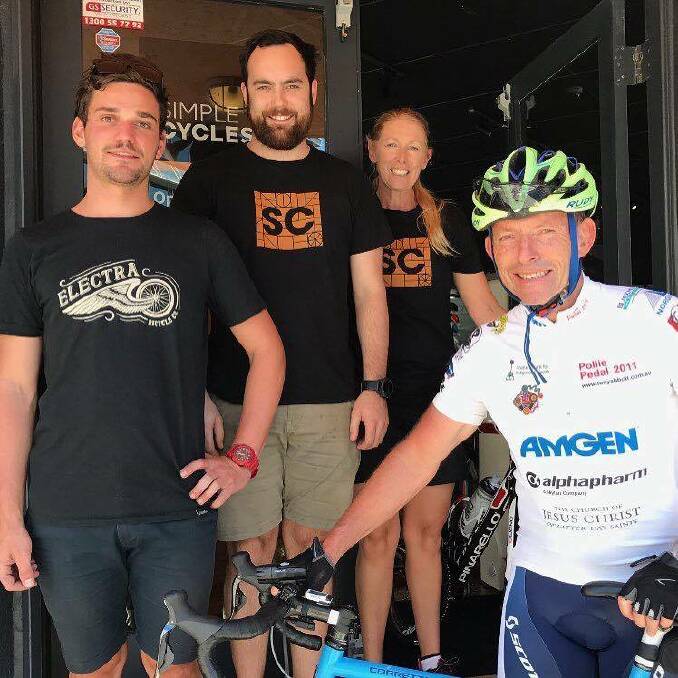Former PM, and current Member for Warringah, Tony Abbott meets with staff at Simple Cycles during a ride through Wollongong this week. Picture: Supplied