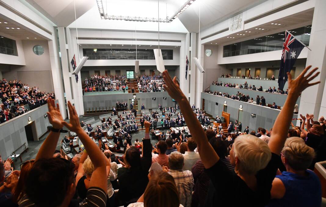Members celebrate before the passing of the Marriage Amendment Bill in the House of Representatives at Parliament House in Canberra on Thursday. Picture: Mick Tsikas / AAP