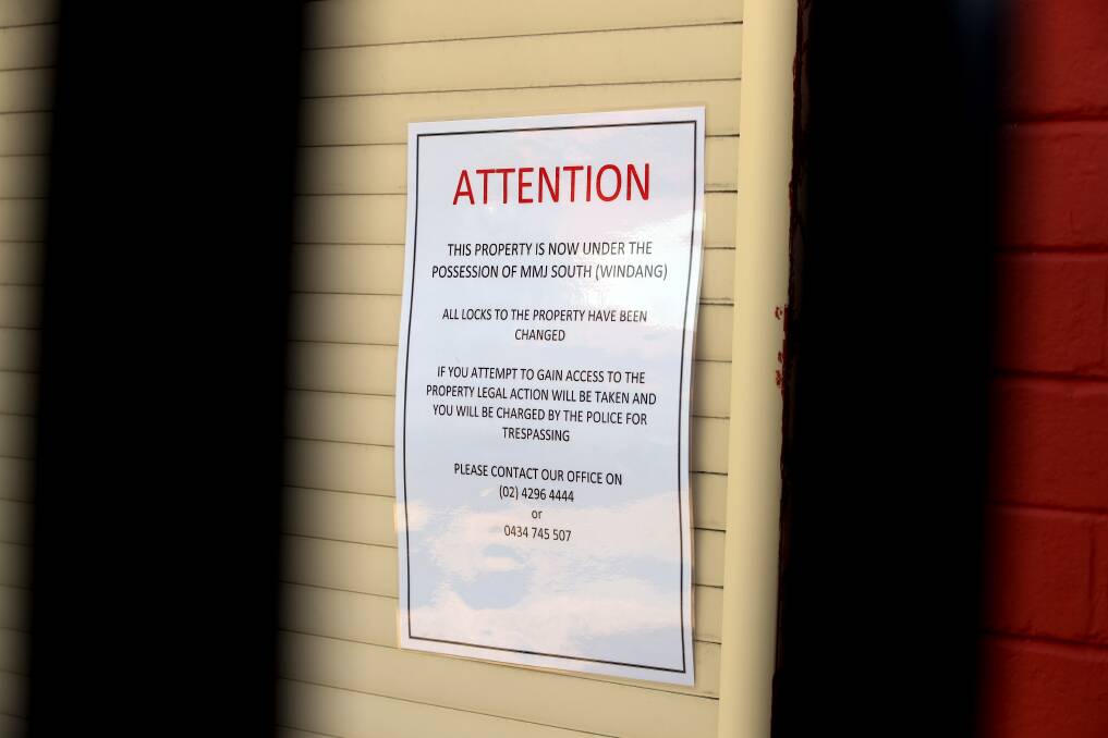 WARNING SIGN: A laminated piece of paper outside the shop says the business' locks have been changed and warns against people gaining access. Picture: Robert Peet