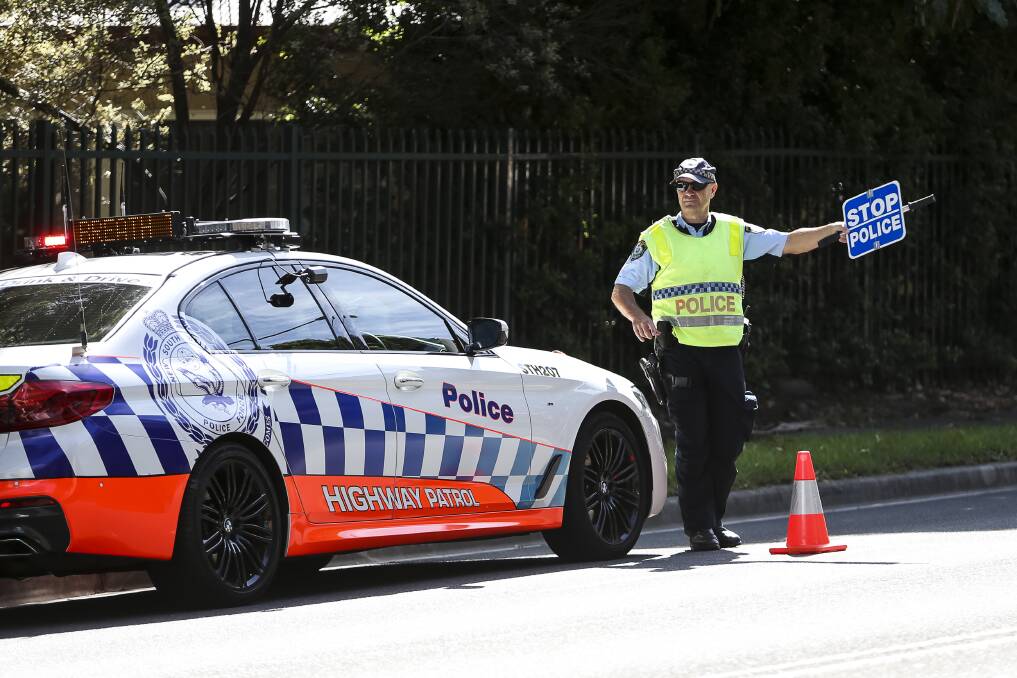 Highway patrol officers at a random breath testing site on Throsby Drive, Wollongong, on Saturday morning. Picture: Anna Warr