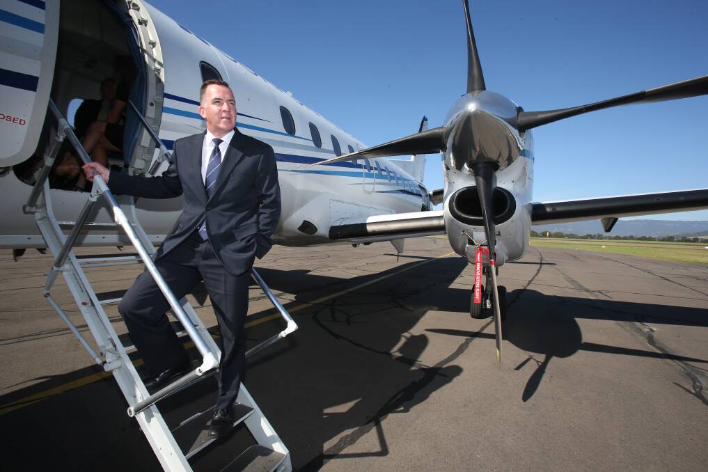 Fly Corporate's sales manager Geoff Woodham with the plane at the Illawarra Regional Airport this week. Picture: Robert Peet