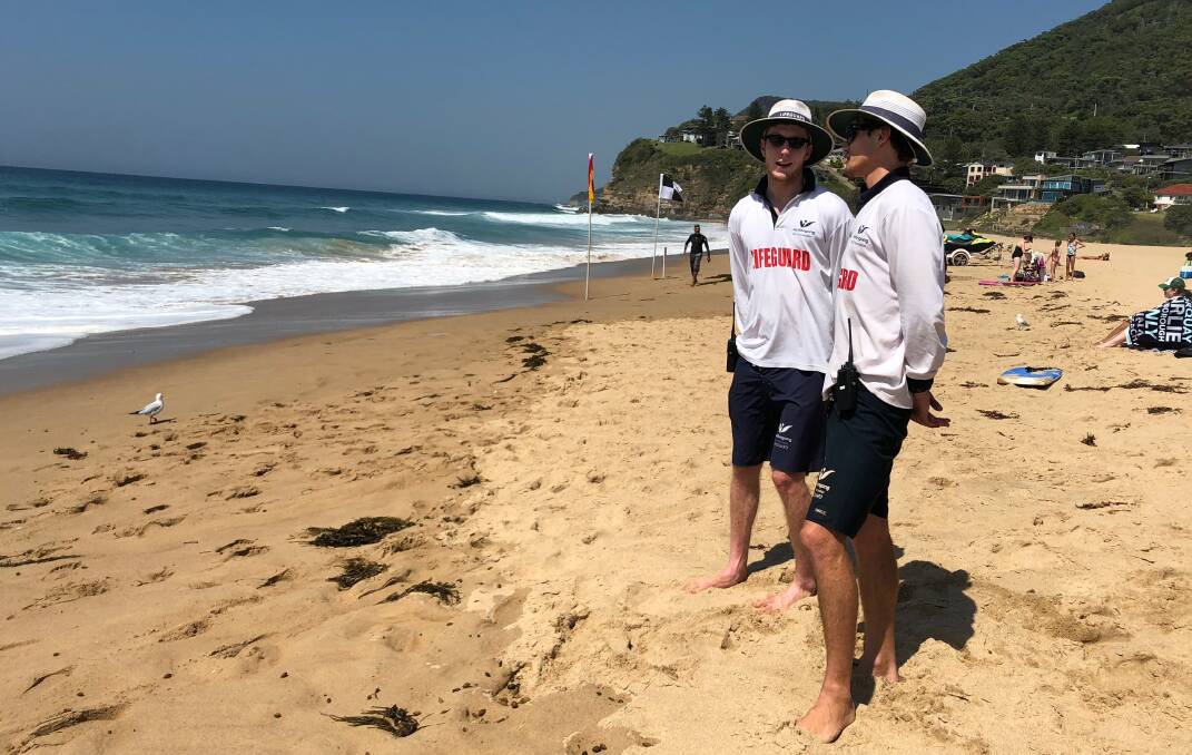 Wollongong City Council lifeguards Harry Steele (left) and Luke Essenstam at work on Friday after helping save a paraglider pilot. Picture: Andrew Pearson