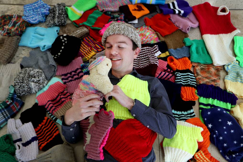 WARMTH: Journalist Andrew Pearson, who coordinated the collection, with some of the hand-knitted lamb jumpers donated via the Mercury's front desk. Picture: Sylvia Liber