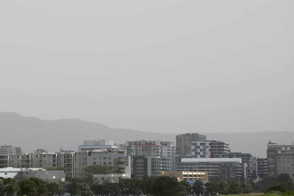 LOW VISIBILITY: The Illawarra Escarpment disappears underneath a blanket of dust, as dry topsoil blown from inland NSW arrives in Wollongong. Pictures: Adam McLean