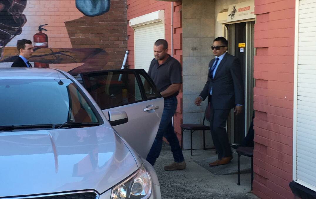 UNDER ARREST: Shane Simpson is taken into custody at his Port Kembla business on Wednesday morning. The 46-year-old is behind bars. Picture: Nine News Illawarra