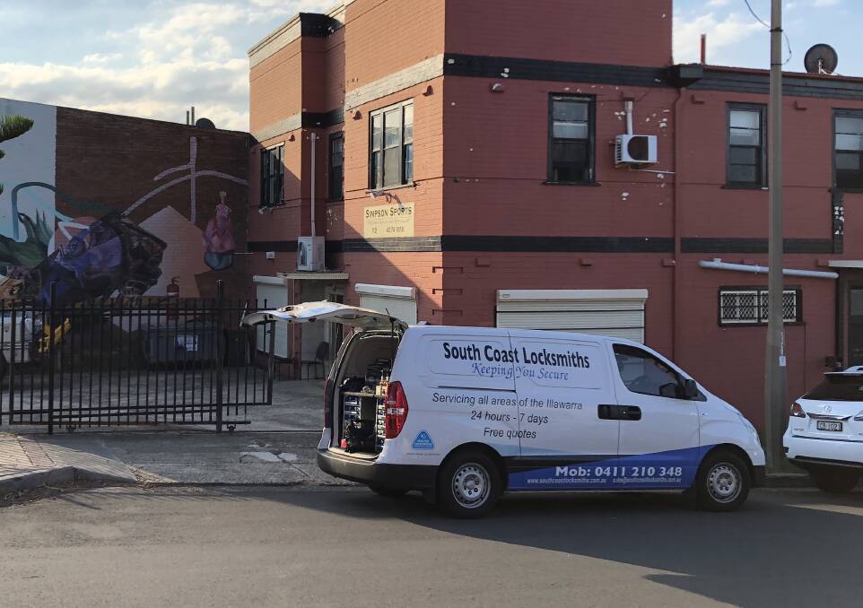 LOCKED OUT: Locksmiths at the Simpson Sports firearms and hunting specialist store, on the corner of Wentworth and Fitzwilliam streets, on Friday. Picture: Andrew Pearson