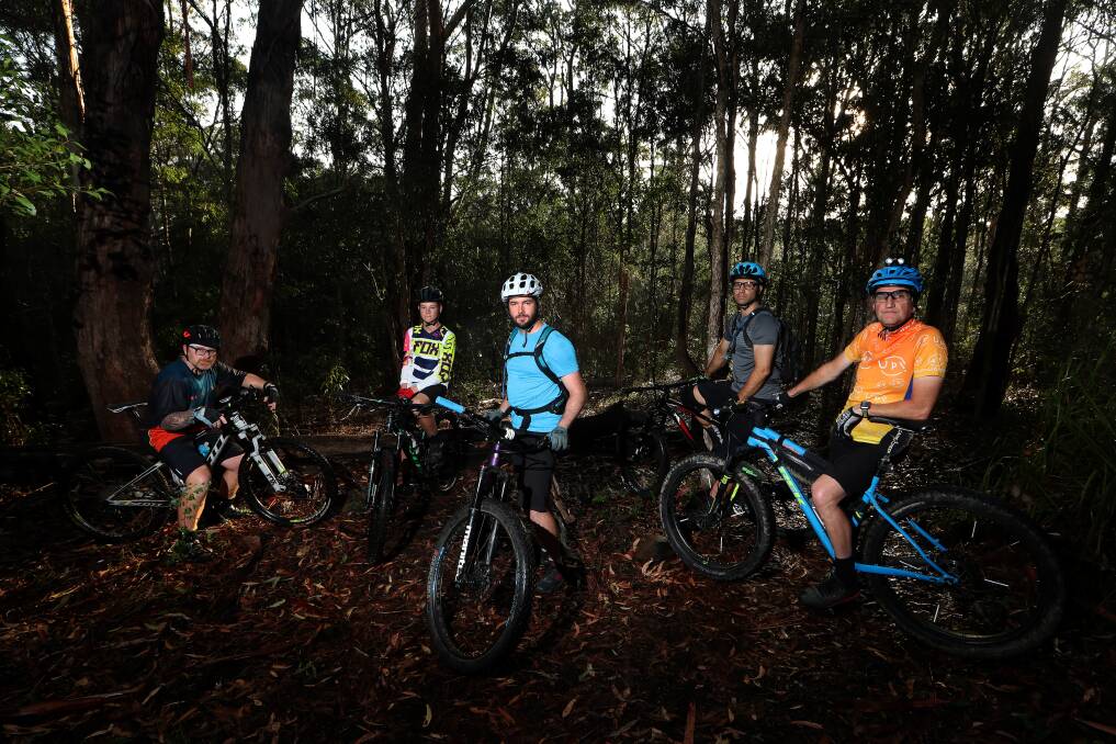 CONCERN: Mick Langdon (left), Flynn Langdon, Luke Perry-Gore, Rob Cohen and Tim Manton at Blackbutt Reserve. The riders say large obstacles are being deliberately placed on trails. Picture: Sylvia Liber | ONLINE: SEE THE OBSTACLES