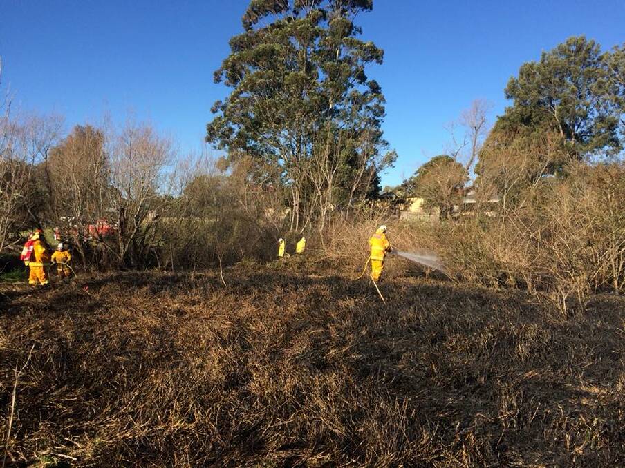 Firefighters work to put out a grass fire at Avondale last week. Gusty winds and the lengthy dry spell combine for potentially dangerous fire conditions, even during the middle of winter, according to the Rural Fire Service (RFS). Picture: NSW RFS Illawarra District
