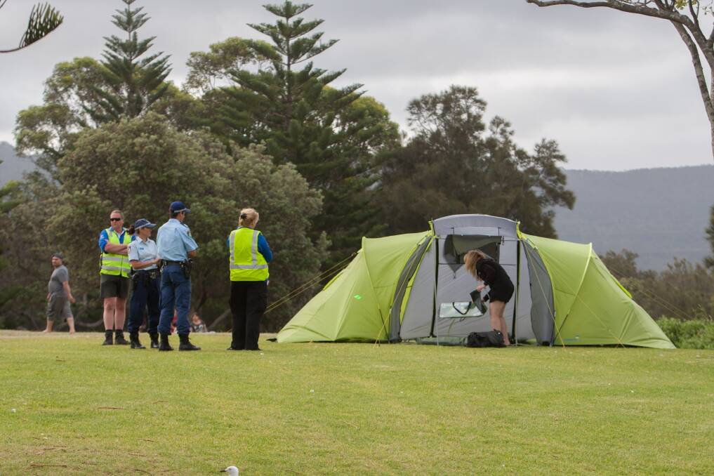 Council rangers and police officers at Stuart Park on December 31, 2014 - ensuring tents are packed away by the evening deadline. Picture: Christopher Chan
